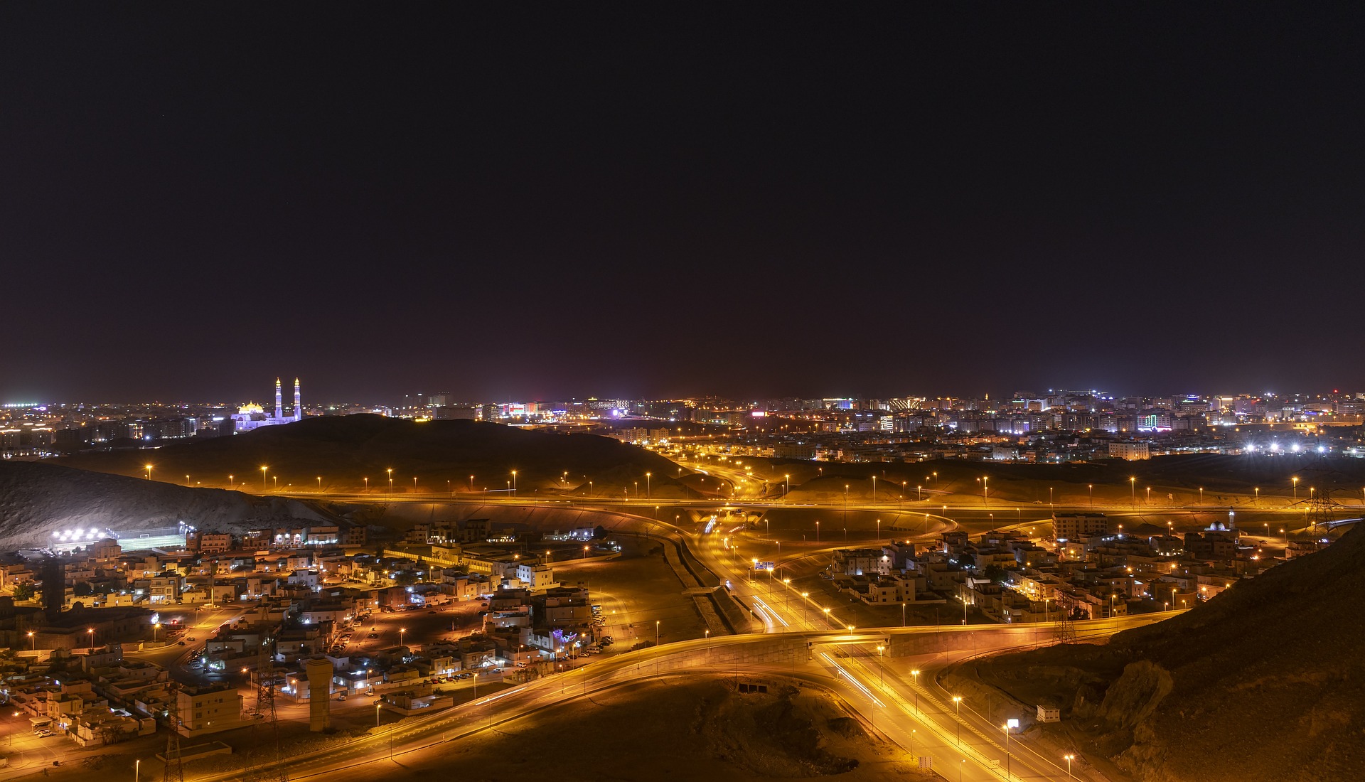 Oman city skyline illuminated at night